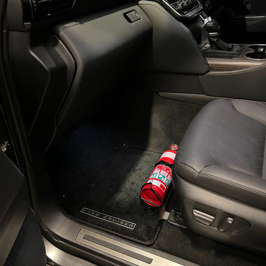 Scrub King fire extinguisher bracket fitted to Toyota LandCruiser 300 Series passenger seat rail, matte black