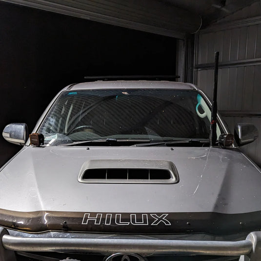 Toyota Hilux N70 with LED ditch lights mounted via Scrub King bonnet hinge brackets on outback track